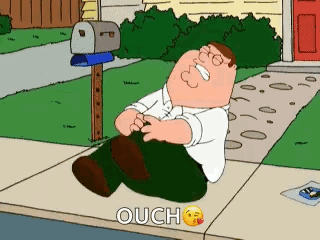 Peter Griffin falls on a sidewalk clutching his leg in Family Guy.