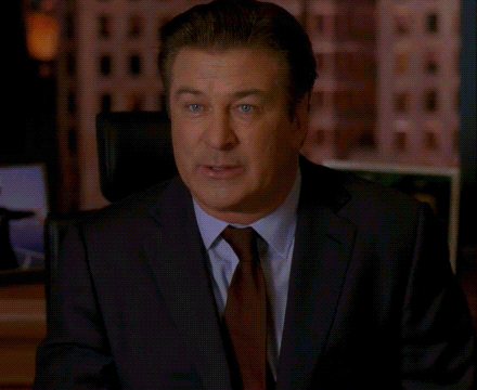 a man in a suit and tie is sitting in front of a screen that says request denied