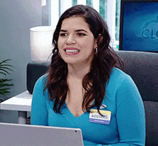 a woman wearing a name tag with the name adenre on it