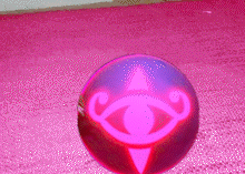 a purple ball with the letter g on it is on a pink surface