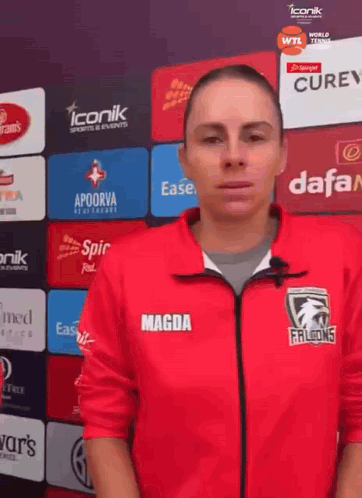 a woman wearing a red jacket with magda on the front