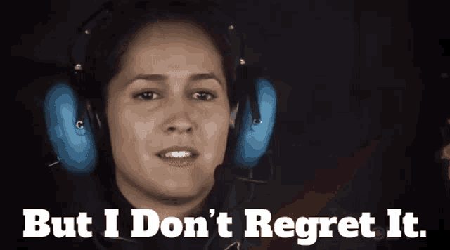 a woman wearing headphones with the words but i don 't regret it below her