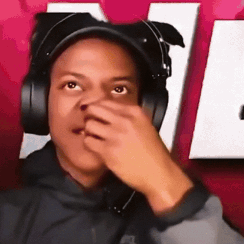IShowSpeed covers his nose while giving a confused look.