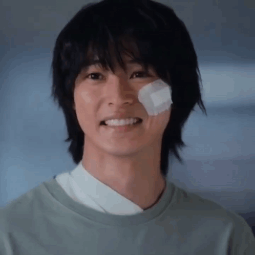 a close up of a young man with a bandage on his face .