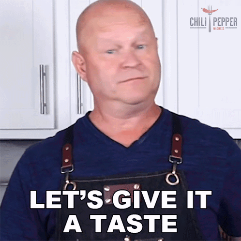 a man in an apron is saying " let 's give it a taste "