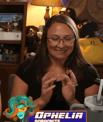 a woman wearing glasses is smiling in front of a sign that says gorgonite
