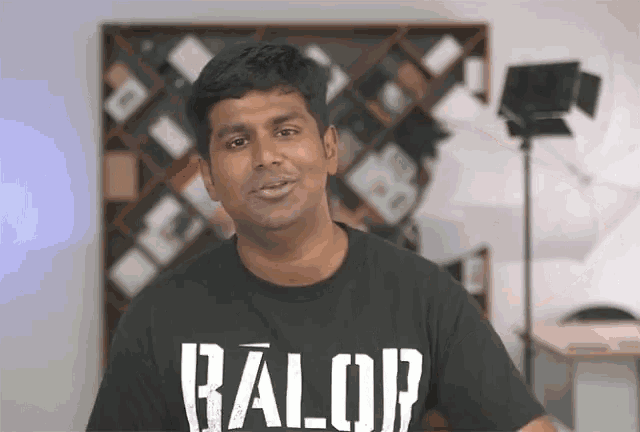 a man wearing a black t-shirt with the word balop on it