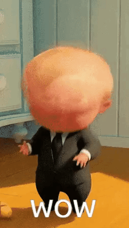 A large-headed animated boy in a dark suit stands in a hallway with “WOW” text.