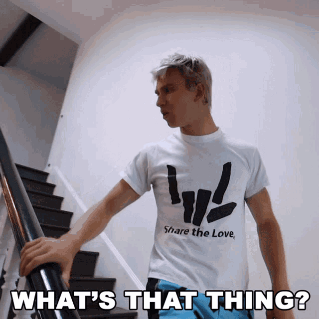 a man wearing a shirt that says share the love is walking down stairs