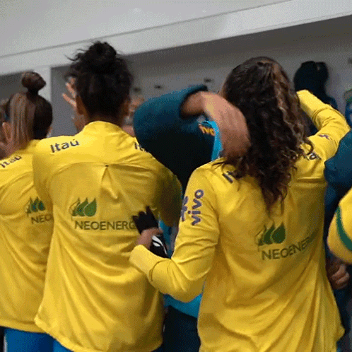 a group of people wearing yellow shirts with neoenerg on the back
