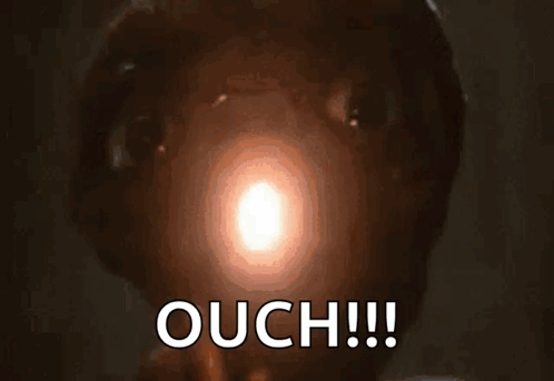 A glowing light appears in a dark scene beneath the large caption “OUCH!!!”