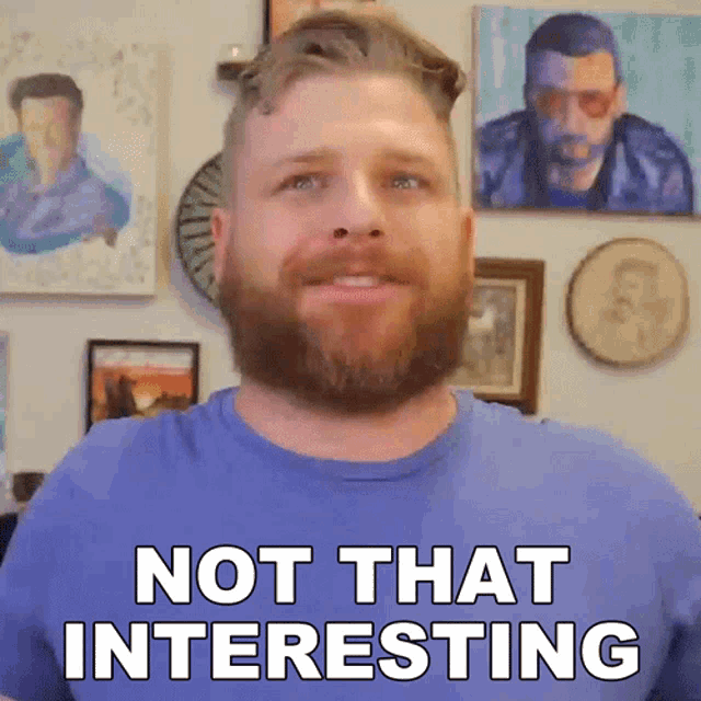 a man with a beard is wearing a blue shirt that says " not that interesting "