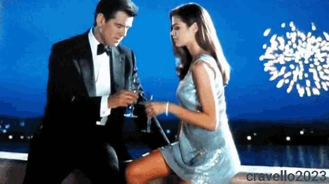 a man in a tuxedo holds a glass of champagne next to a woman in a dress with the watermark cravello2023