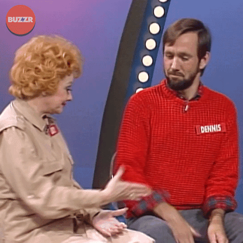 a man wearing a red sweater with dennis written on it