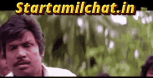 a man with a mustache is standing in front of a sign that says startamilchat.in