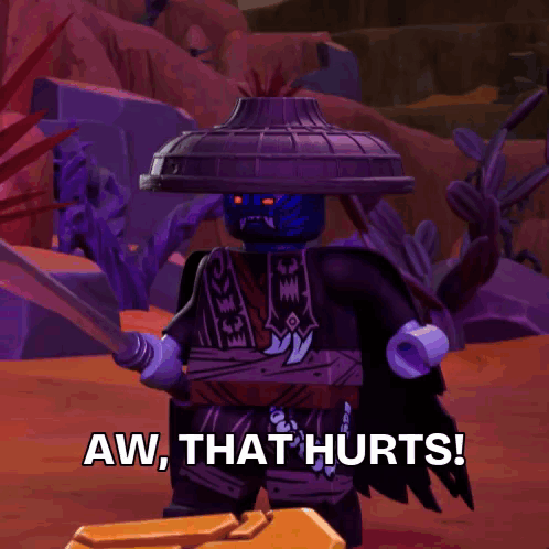 A Lego Ninjago character raises both hands under the caption “AW, THAT HURTS!”