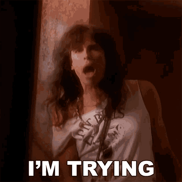 a woman is screaming with the words i 'm trying above her