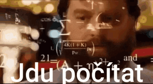 a man with a beard is looking at a computer screen with mathematical equations coming out of his eyes .