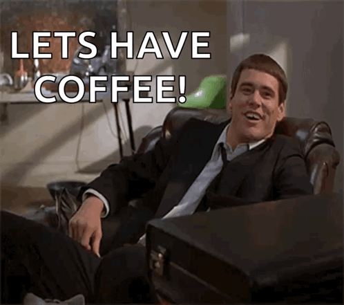 a man in a suit and tie is sitting in a chair and says lets have coffee