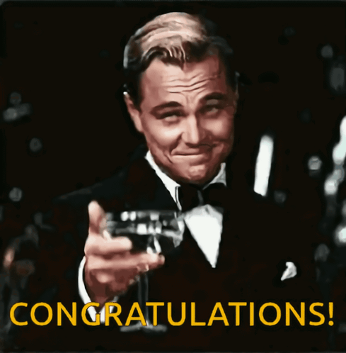 Leonardo DiCaprio raises a champagne glass in a tuxedo with a “CONGRATULATIONS!” caption.