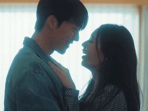 a man and a woman looking into each others eyes