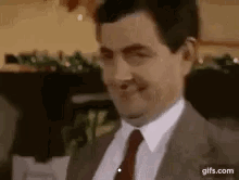 Mr. Bean looks sideways and winks.