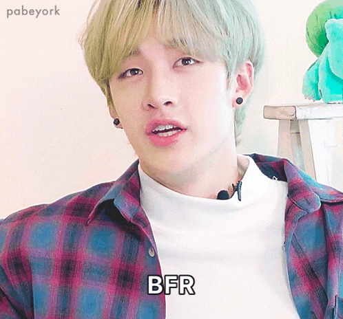 a young man wearing a plaid shirt has the word bfr written on his shirt