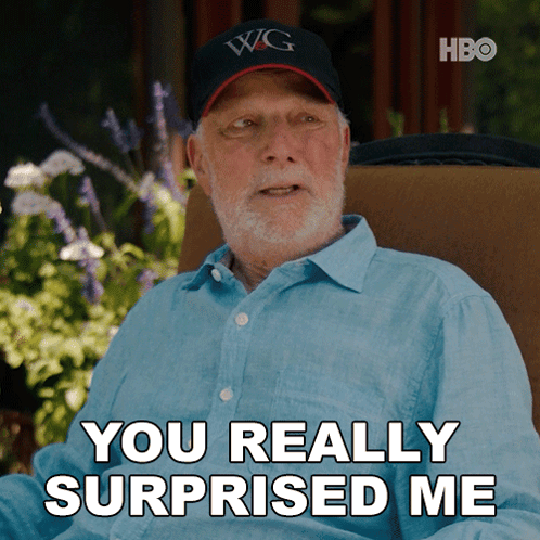 an older man wearing a hat that says wg is sitting in a chair and says you really surprised me