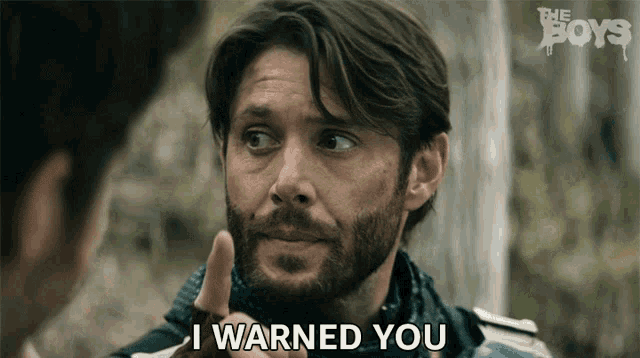 a man with a beard is talking to another man and says i warned you