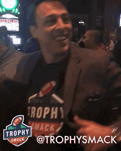 a trophy smack logo is above a man