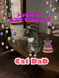 a cat sitting on a table with a birthday cake and the words happy birthday catdad
