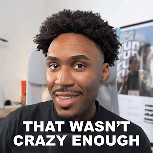 a man with curly hair is smiling with the words that wasn 't crazy enough below him