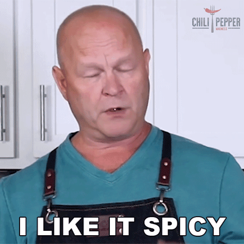 a man wearing an apron is saying i like it spicy