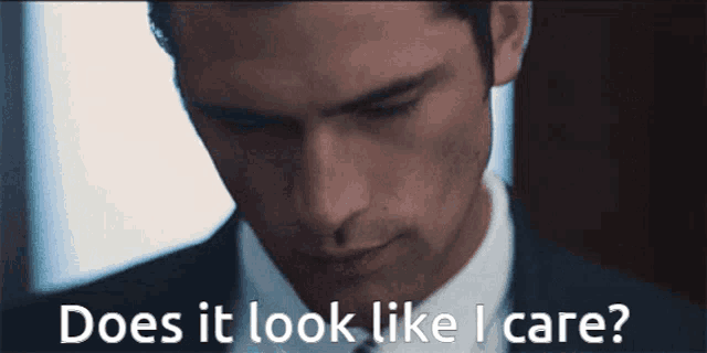 a man in a suit and tie is asking does it look like i care