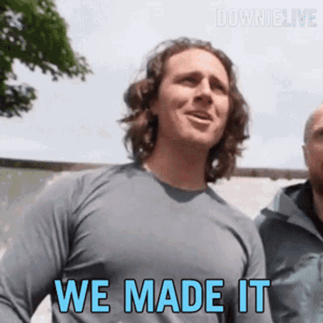 a man in a grey shirt says we made it in blue letters