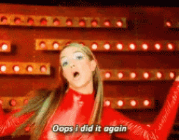 Britney Spears performs in a red outfit with “Oops i did it again” text.
