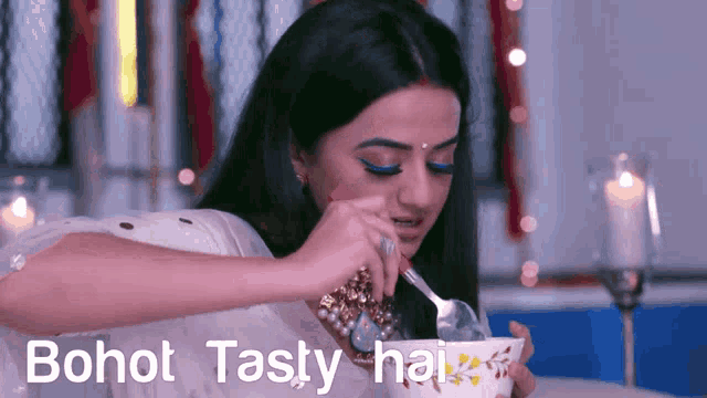 a woman is eating from a bowl with the words bohot tasty hai written on the bottom