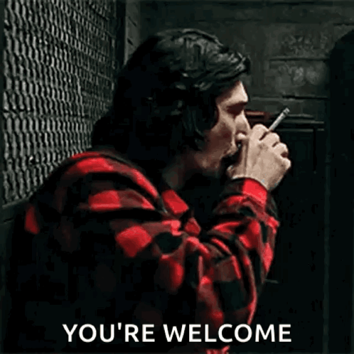 a man in a plaid shirt is smoking a cigarette and drinking coffee .