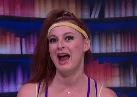 Rachel Reilly speaks animatedly in a purple outfit on Big Brother.