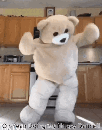 A person in a large mascot costume dances in a kitchen.