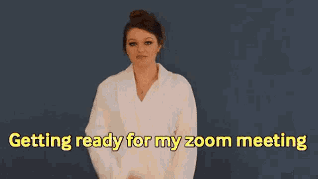 a man and a woman are standing next to each other and the woman is wearing a robe .