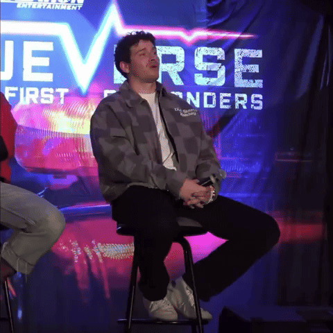 a man sitting on a stool in front of a sign that says jeverse first enders