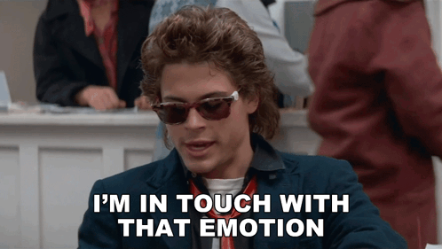 a man wearing sunglasses and a suit says " i 'm in touch with that emotion "