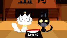 a black cat and a white cat are standing next to a bowl of milk