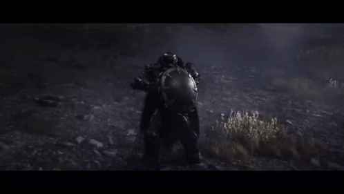 a person in a helmet is standing in the dark in a field .