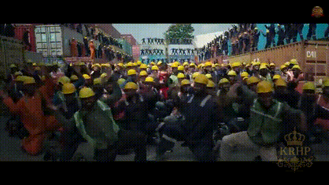 a group of people wearing hard hats are walking down a street