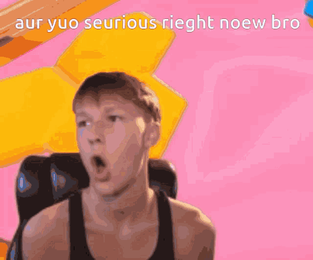 a man in a black tank top is sitting in front of a pink background with the word elien on it