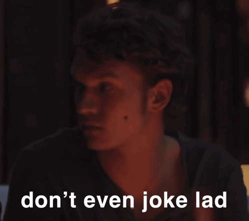 a man in a dark room with the words " don 't even joke lad " written below him