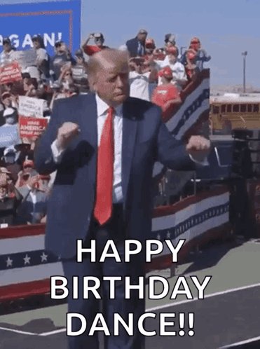 a man in a suit and tie is dancing in front of a crowd and says happy birthday dance .