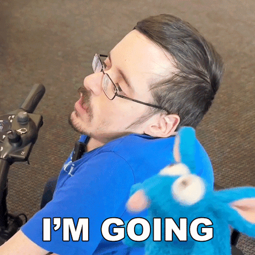 a man in a wheelchair says i 'm going in front of a stuffed cookie monster